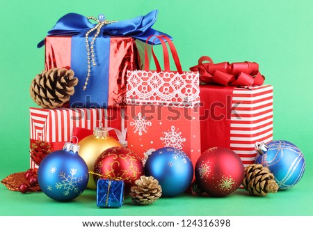 New Year composition of New Year\'s decor and gifts on green background