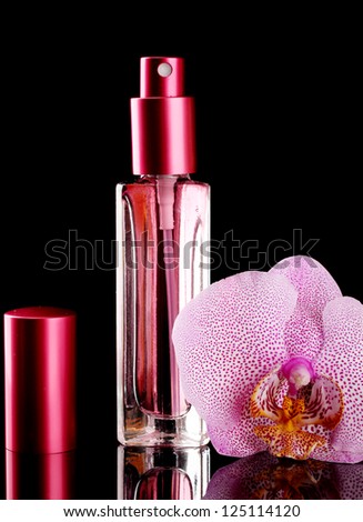 women\'s perfume in beautiful bottle and orchid flower, on black background