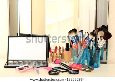 cosmetics on table near mirrow