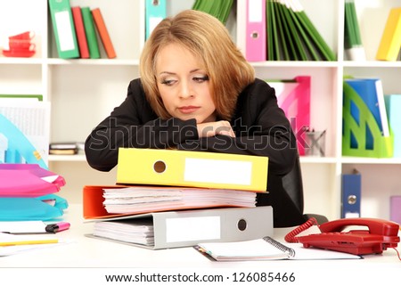 Tired business woman working in office