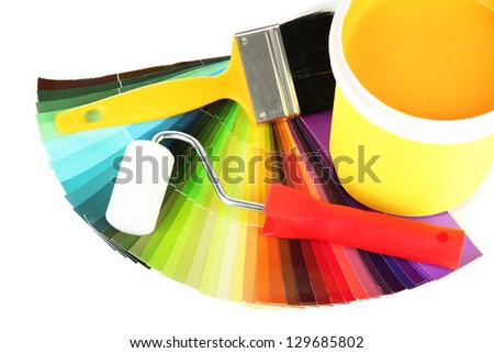 Set for painting: paint pot, brushes, paint-roller and colored palette isolated on white