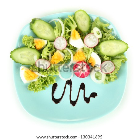Fresh mixed salad with eggs, salad leaves and other vegetables on color plate, isolated on white