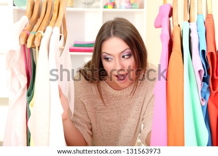Young girl in shop buying clothes