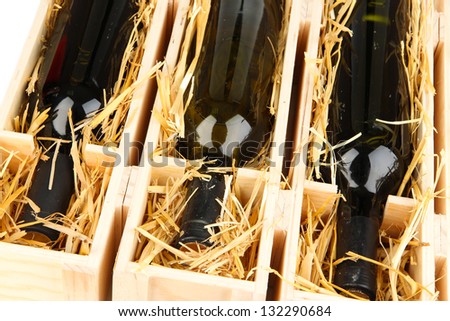 Wooden case with wine bottles close up