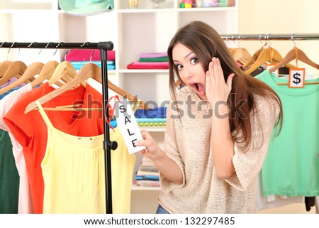 Young girl in shop buying clothes