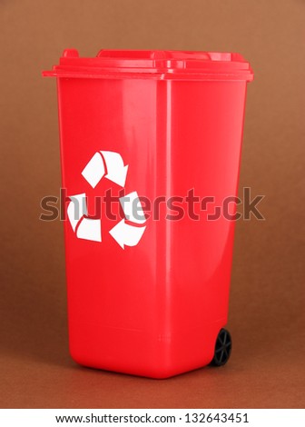 Recycling bin on brown background