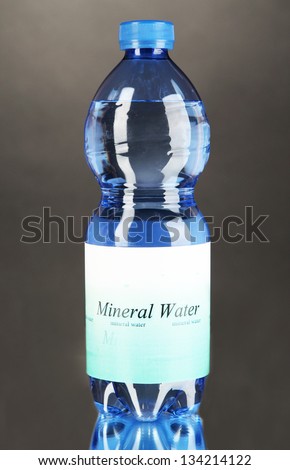 Water bottle with label on grey background
