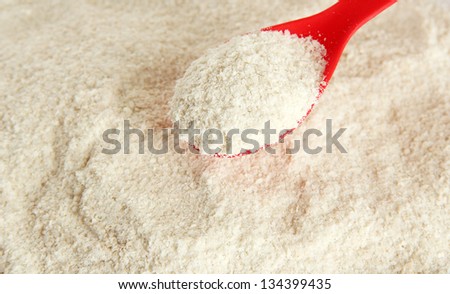 Powdered milk with spoon for baby close-up