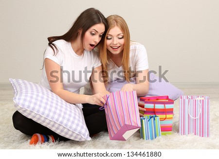 Two girl friends out gifts on room