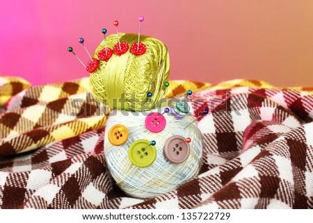 Buttons of different colors, and the two tangle thread on a colorful background
