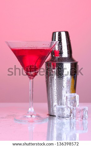 Cocktail shaker and cocktail on red background