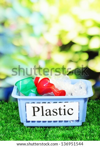 Assorted trash in baskets on nature background
