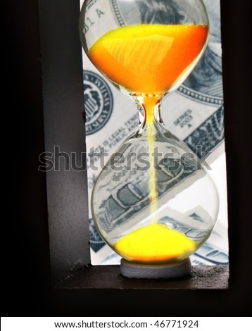 Sand clock with gold sand on dollar background