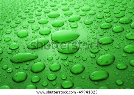 Green water drops background with big and small drops