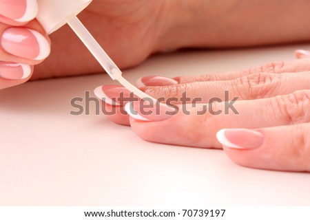 Beautiful woman hands with french manicure on white background