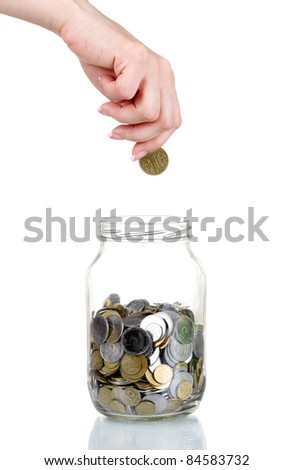 Glass bank for tips with money and hand isolated on white. Ukrainian coins