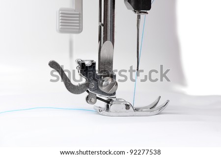 sewing machine and white fabric isolated on white