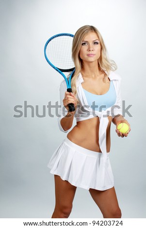 Young girl with tennis racket isolated on white