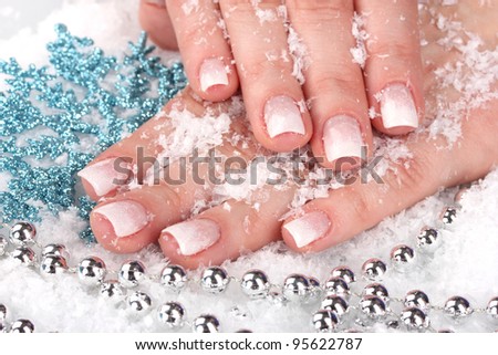 hands with snow, snowflakes and beads closeup