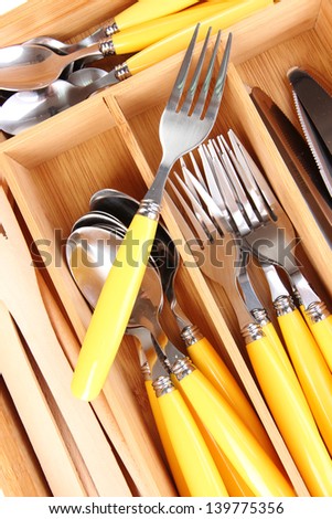 Checked cutlery in wooden cutlery box close up