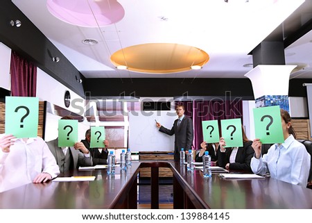 Businessmen with question marks on their faces before business training