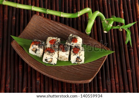 Tasty Maki sushi - Roll on plate on bamboo mat