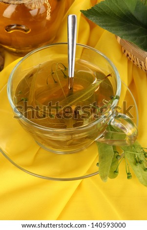 Glass cup of tea with linden on napkin close-up