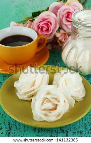 Sugar roses and natural roses, glass jar with sugar,  on color background