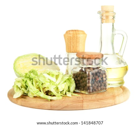 Green cabbage, oil, spices on cutting board, isolated on white