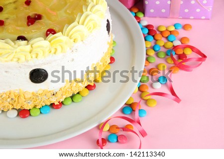 Happy birthday cake and gifts, on pink background