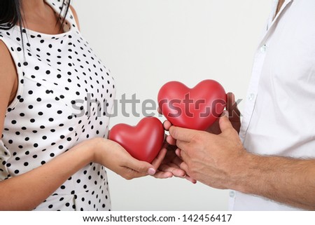Beautiful loving couple with heart on grey background