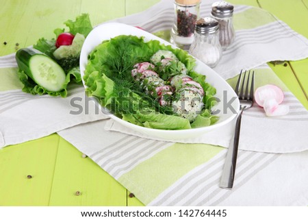 Vitamin vegetable salad in bowl on wooden table close-up