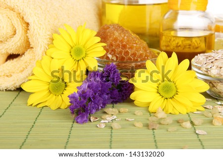 Fragrant honey spa with oils and honey on wooden table close-up