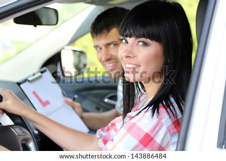 Beautiful young woman  taking driving lesson