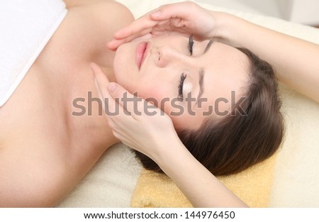 Beautiful young woman in cosmetic salon close up