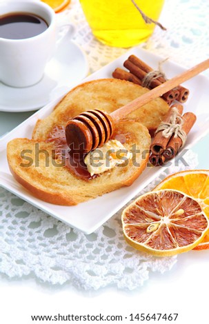 White bread toast with honey and cup of coffee, isolated on white