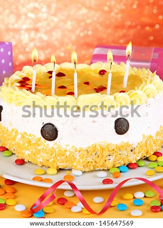 Happy birthday cake and gifts, on red background