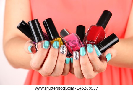 Woman hands with nail polishes, close-up