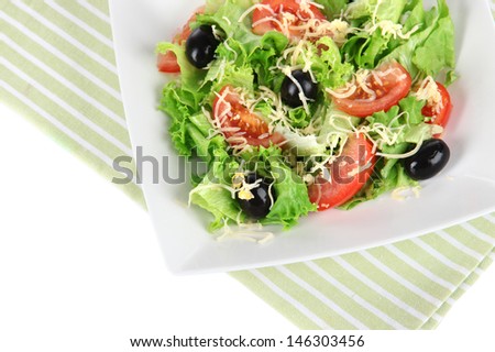 Light salad on plate on napkin  isolated on white