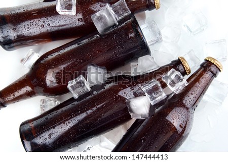 Beer bottles in ice cubes close up