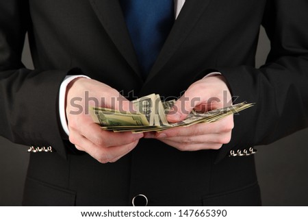 Business man counts money close-up