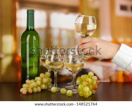 Tasting white wine on room background