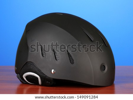 Winter sport helmet on blue background