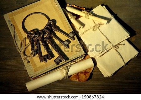 Antique keys, letters and book, on dark background