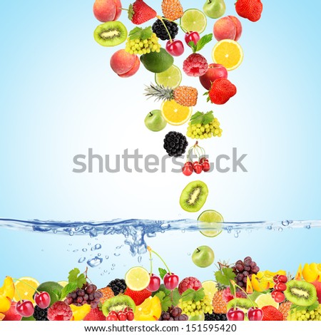 Flight fruits and berries in water on blue background