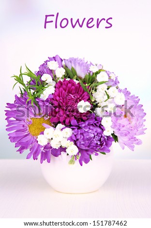 Beautiful bouquet of bright flowers in vase on bright background
