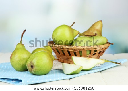 Pears in  wicker basket, on light background