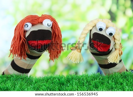 Cute sock puppet on bright background