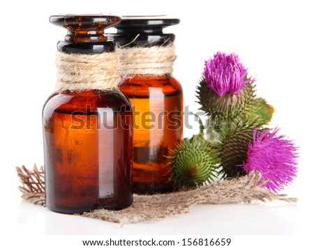 Medicine bottles with thistle flowers, isolated on white