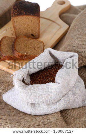 Cloth bag with buckwheat and bread closeup